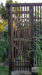 Garden gate with hidden magnetic latch using two countersunk, rubber-coated neodymium magnets.