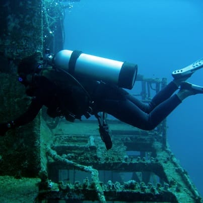 Scuba diver exploring ship wreck