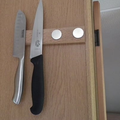 Bespoke beech effect caravan knife rack using four self-adhesive neodymium magnets showing two knives