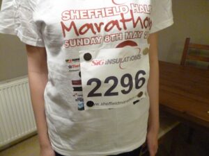 Torso of a runner wearing a running shirt with number attached with magnets