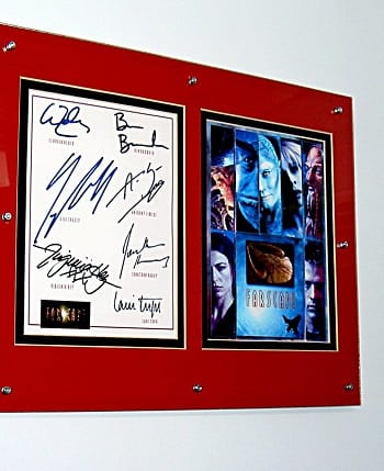 Farscape signed picture in a glass clip frame held together with rivets and hung on a metal wall with ferrite channel magnets