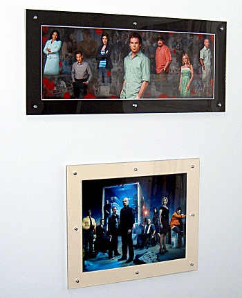 Dexter and Breaking Bad pictures in clip frames held together with rivets and stuck to a metal wall with ferrite channel magnets