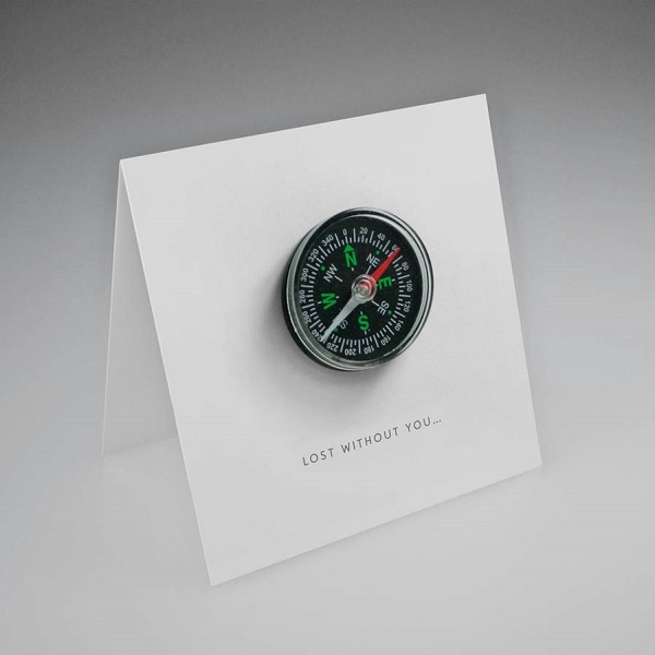 Bespoke greeting card with an attached compass that reads 'lost without you'