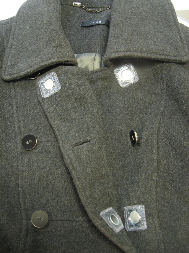 A coat with stitch-in magnets placed behind the buttons