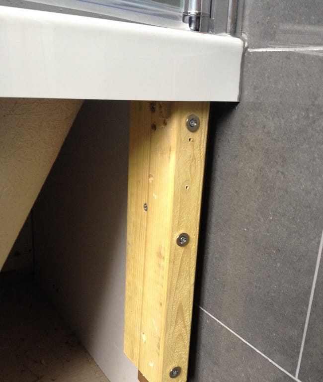 Countersunk steel discs screwed into a bath panel timber frame