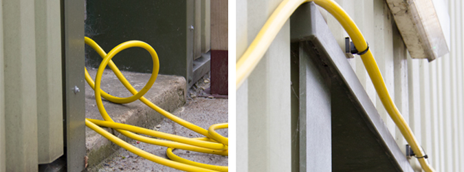 Before and after of an untidy hose mounted against a steel clad wall