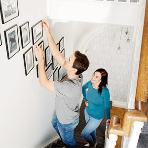 Man hanging picture fram on magnetic wall