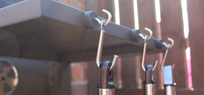 Three magnetic hooks attached to a grill